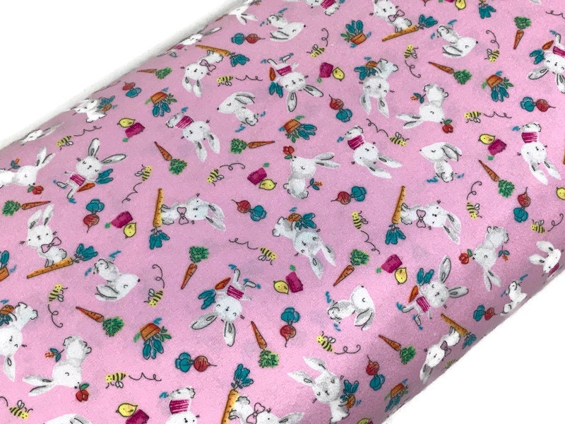 Flannel Bunny Fabric Sold by the YARD. 100% Cotton Easter Fabric. White Rabbits on Pink, Green Accents. For Quilts, Clothing, Nursery Décor.