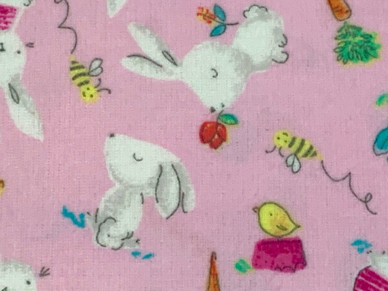 Flannel Bunny Fabric Sold by the YARD. 100% Cotton Easter Fabric. White Rabbits on Pink, Green Accents. For Quilts, Clothing, Nursery Décor.