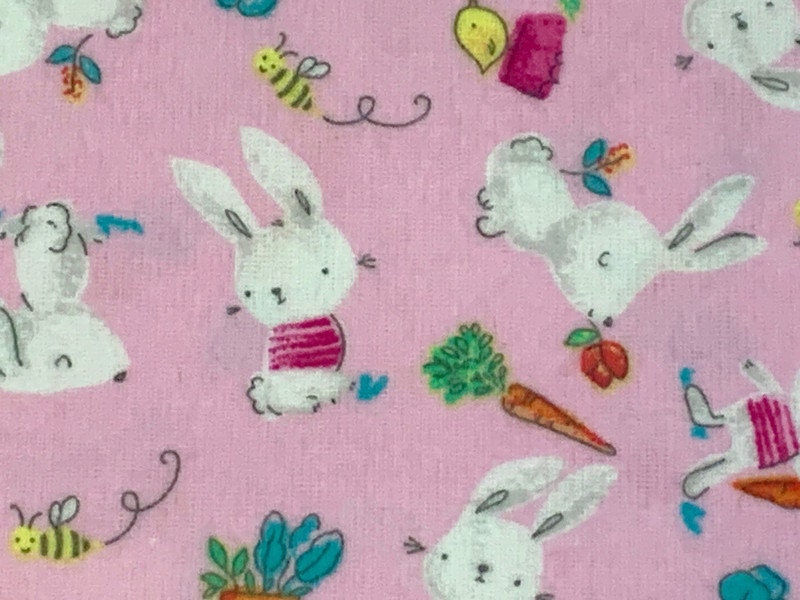 Flannel Bunny Fabric Sold by the YARD. 100% Cotton Easter Fabric. White Rabbits on Pink, Green Accents. For Quilts, Clothing, Nursery Décor.